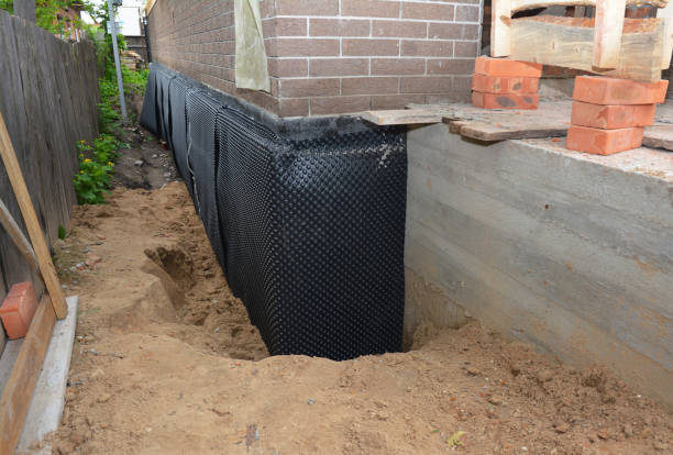Happy homeowners after waterproofing job in Guilford